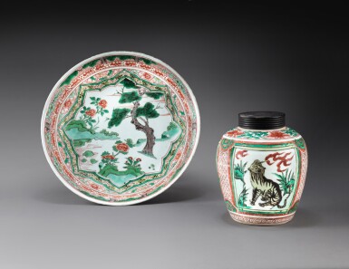 View full screen - View 1 of Lot 178. A wucai 'mythical beast' jar and a wucai 'pine' dish Ming dynasty, Wanli period | 明萬曆 五彩瑞獸紋罐及開光松樹圖盤一組兩件.