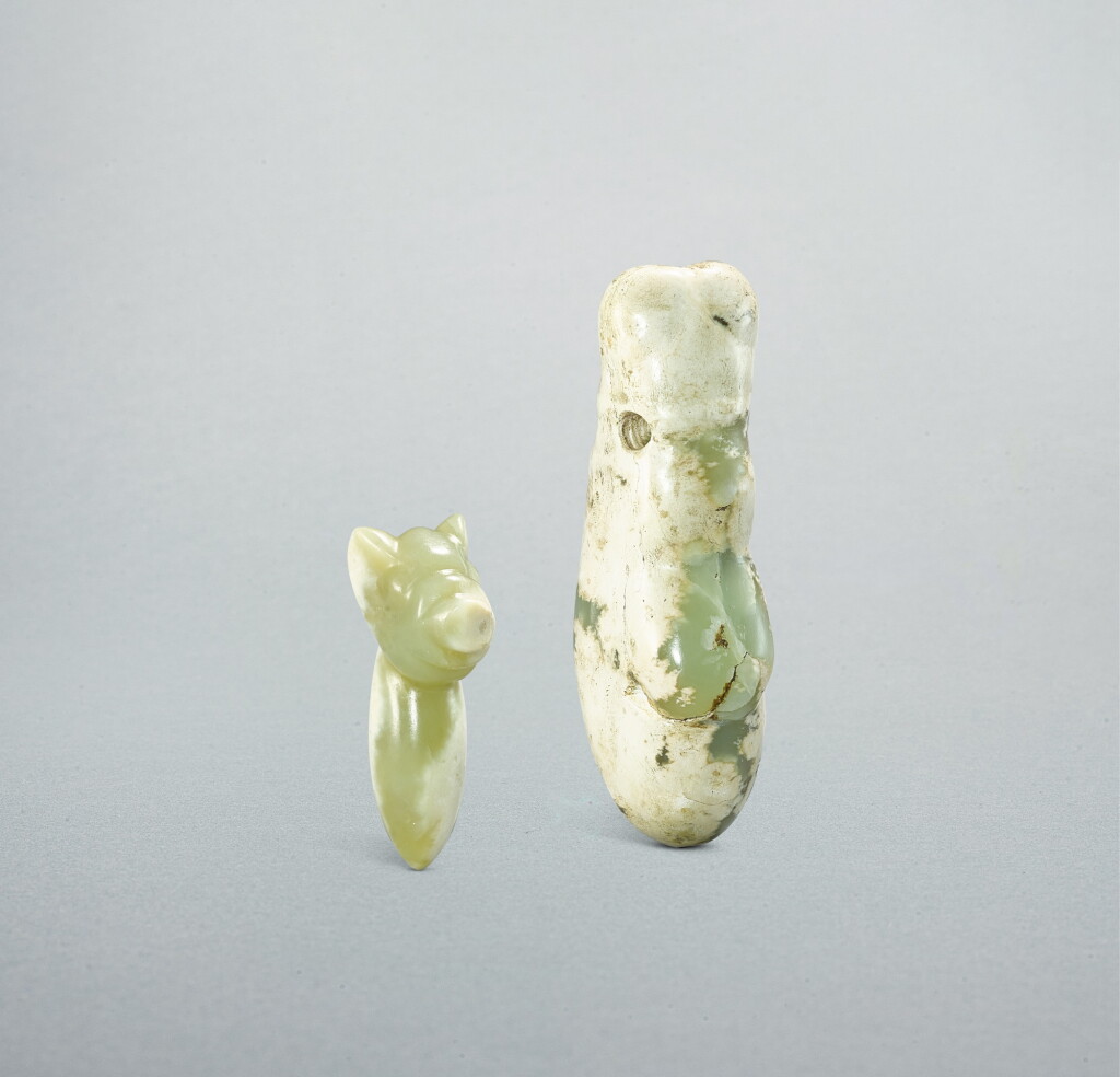 View full screen - View 1 of Lot 718. A celadon jade 'pig' pendant and a celadon jade 'cicada' pendant, Neolithic period, Hongshan culture | 新石器時代 紅山文化 青玉豬型及蟬形玉飾.