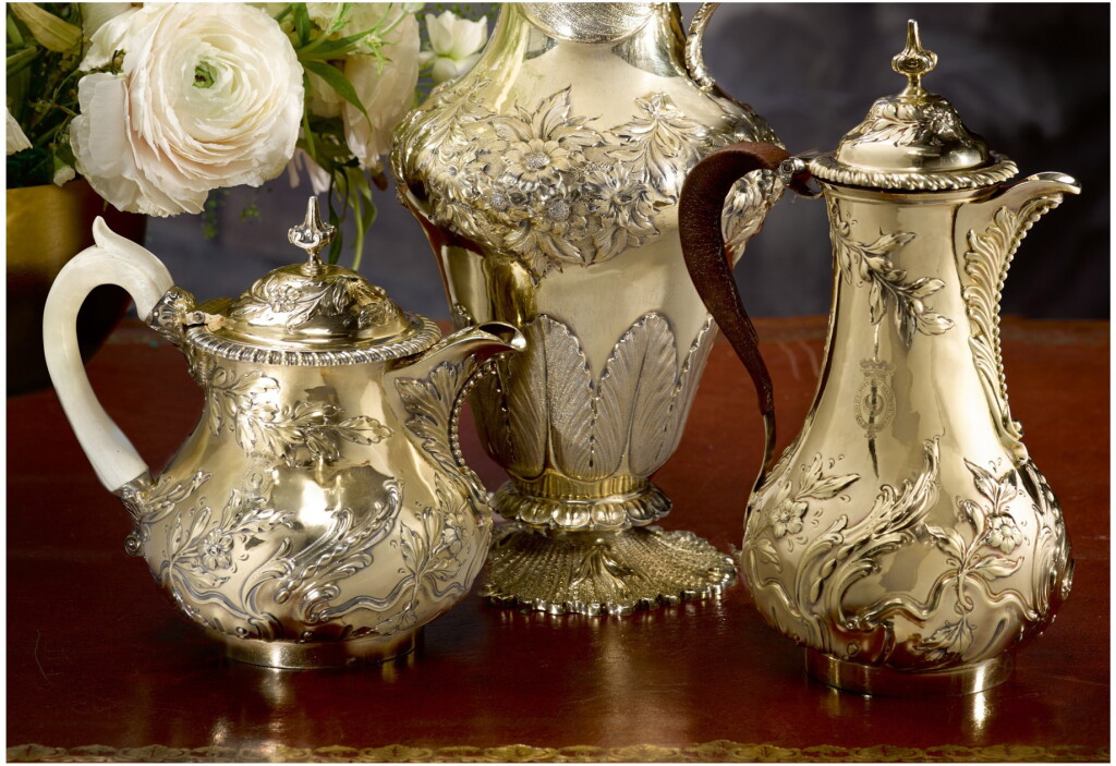 View full screen - View 1 of Lot 15. A GEORGE III SILVER-GILT HOT WATER JUG AND MATCHING GEORGE IV SILVER-GILT TEAPOT, MAKER'S MARK IB OVER WB (GRIMWADE 1982 #3626) / WILLIAM ELLIOTT, LONDON, 1764 / 1822.