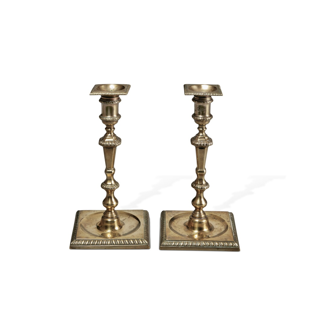 View full screen - View 1 of Lot 834. A Pair of English Cast-Brass Square-Base Candlesticks, circa 1745.