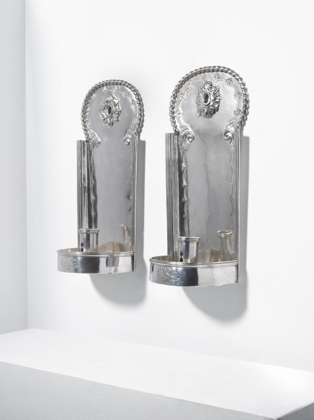 View full screen - View 1 of Lot 101. A pair of Louis XIV silver wall-lights, probably by R. Trabut, Avignon, late 17th- early 18th century.