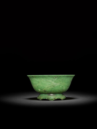 View full screen - View 1 of Lot 8. A Khotan green jade bowl and stand, Qing dynasty, 18th century | 清十八世紀 和闐青玉素撇口盃連菊瓣紋座.