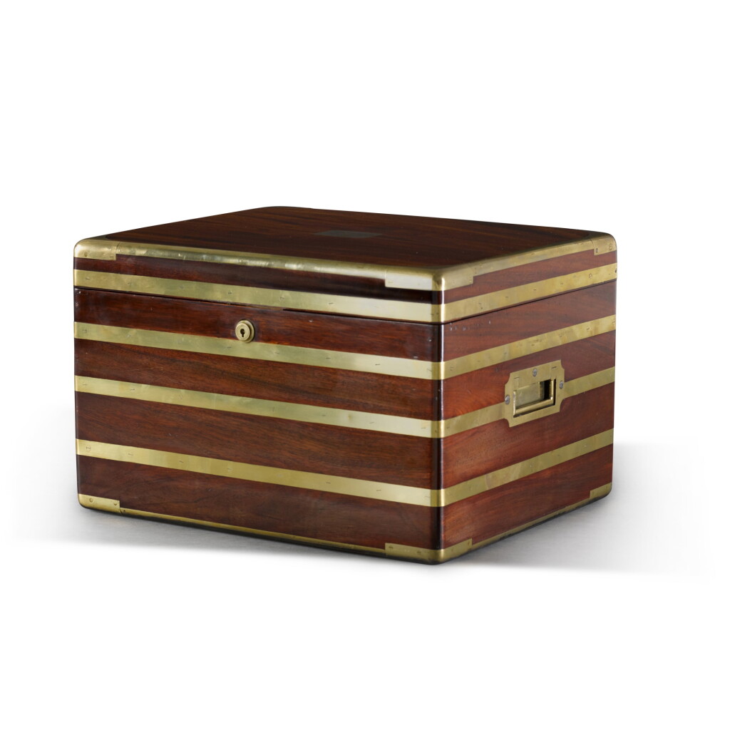 View full screen - View 1 of Lot 101. A VICTORIAN BRASS BOUND MAHOGANY CAMPAIGN BOX LATER FITTED AS A HUMIDOR, LATE 19TH CENTURY.