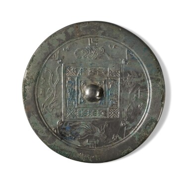 View full screen - View 1 of Lot 107. An inscribed silvered bronze mirror, Han dynasty | 漢 銅鎏銀神獸紋鏡.