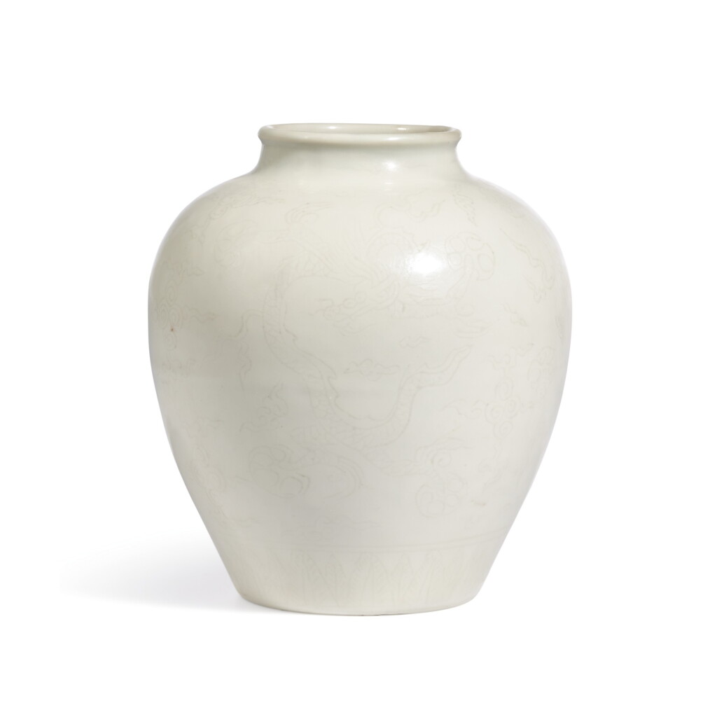 View full screen - View 1 of Lot 3. AN INCISED WHITE-GLAZED 'DRAGON' JAR, JIAJING MARK AND PERIOD | 明嘉靖 白釉暗花雲龍紋罐 《大明嘉靖年製》款.