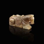 A celadon and russet jade recumbent horse, Ming dynasty 明 青白玉臥馬