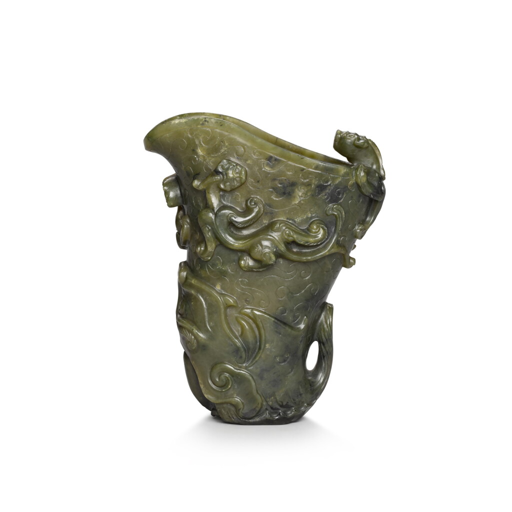 View full screen - View 1 of Lot 70. A spinach-green jade 'Makara' rhyton, Qing dynasty, 18th century | 清十八世紀 碧玉海獸紋首盃.
