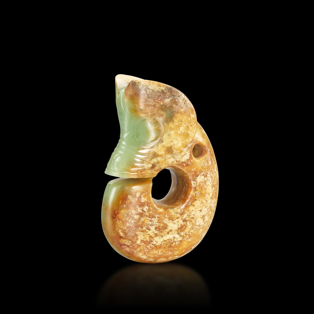 View full screen - View 1 of Lot 412. A celadon and russet jade pig-dragon, Neolithic period, Hongshan culture 新石器時代 紅山文化 青玉豬龍.