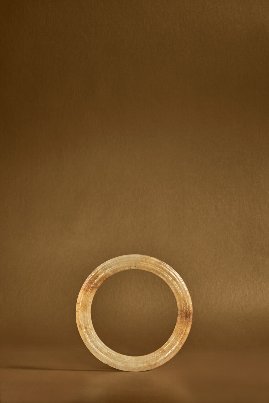 View full screen - View 1 of Lot 110. A carved yellow jade fluted ring (Huan), Eastern Zhou dynasty, Warring States period .