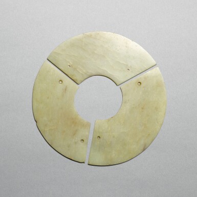 View full screen - View 1 of Lot 720. A pale celadon jade three-arc disc, bi, Neolithic period - early Shang dynasty | 新石器時代至商早期 青玉聯璜玉璧.