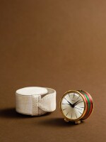 A gilt-brass and enamel miniature travelling drum-form musical alarm clock, Circa 1960s