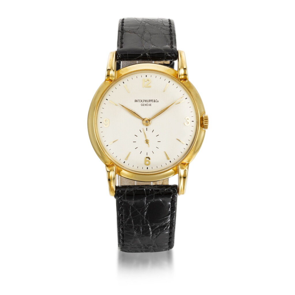 View full screen - View 1 of Lot 701. PATEK PHILIPPE | REF 2420 YELLOW GOLD WRISTWATCH WITH UNUSUAL LUGS MADE IN 1945.
