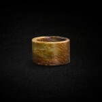 A celadon and russet jade bangle, Neolithic period, probably Dawenkou culture | 新石器時代或大汶口文化 青玉筒形器