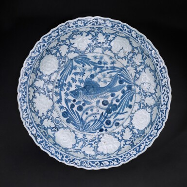 View full screen - View 1 of Lot 13. A unique and highly important moulded blue and white barbed 'fish' charger, Yuan dynasty | 元 青花魚藻凸花牡丹菱口大盤.