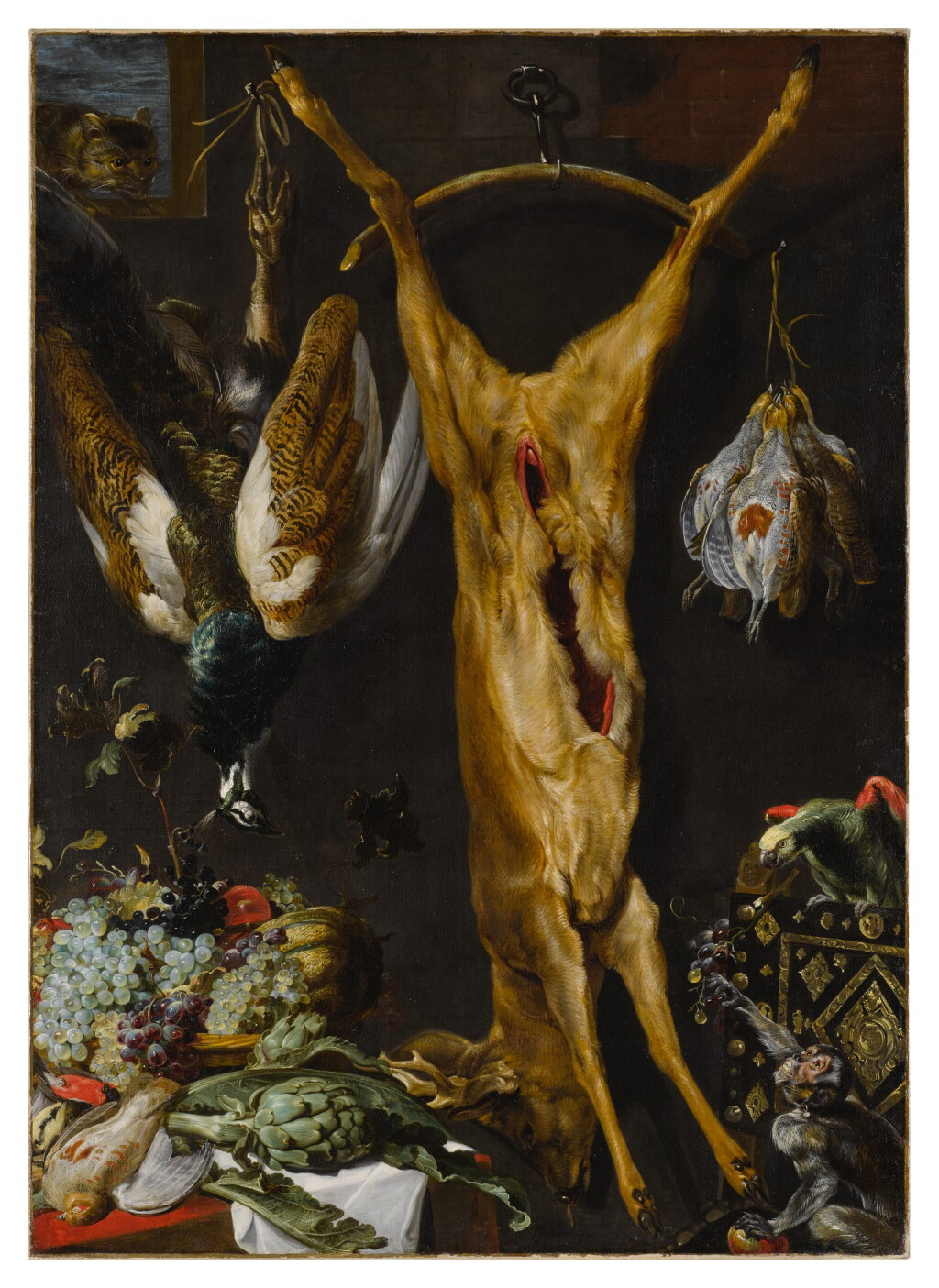 View full screen - View 1 of Lot 524. Still life of artichokes, grapes and a melon in a basket, a hung peacock, roebuck and grouse, together with a parrot and a monkey, a cat jumping through a window beyond.