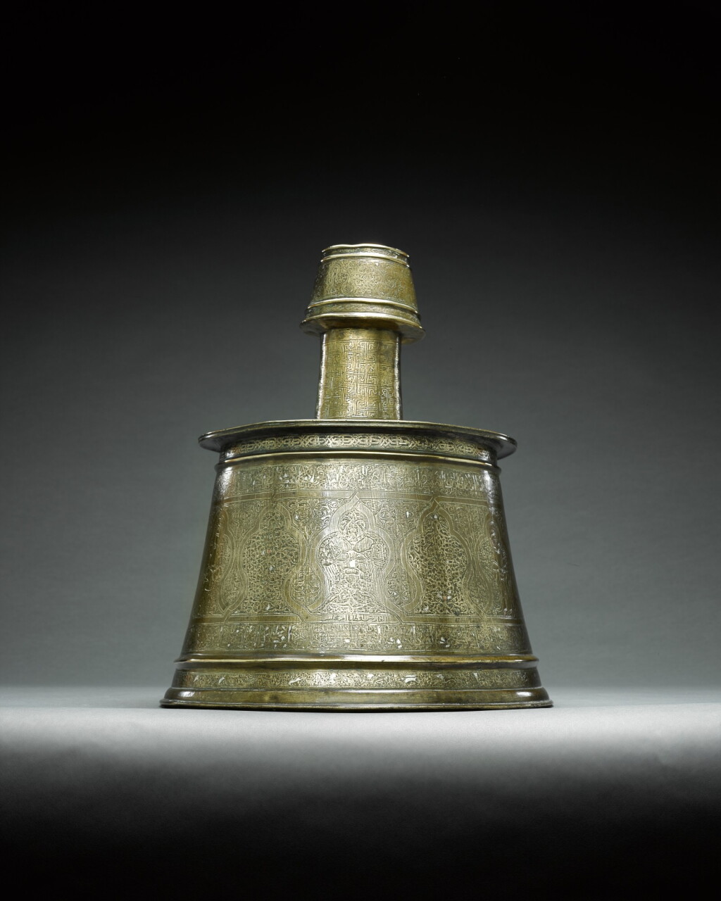 View full screen - View 1 of Lot 98. A large silver-inlaid brass candlestick, Mosul, first half 13th century.