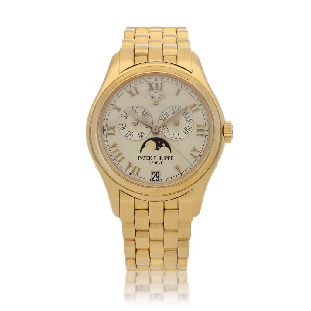View full screen - View 1 of Lot 39. Ref. 5036/1J Yellow gold annual calendar wristwatch with moon phases, power reserve indication and bracelet Circa 2001.