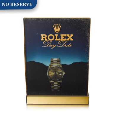 View full screen - View 1 of Lot 8080. ROLEX | DAY-DATE A HEAVY GILT BRASS RETAILER'S LIGHT BOX WITH ADVERTISEMENT, CIRCA 1970.