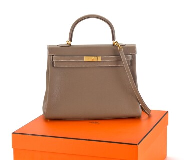 View full screen - View 1 of Lot 8. KELLY 35 RETOURNE ETOUPE COLOUR IN TOGO LEATHER WITH GOLD HARDWARE. HERMÈS, 2017 .