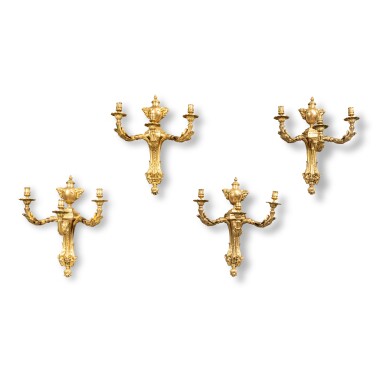 View full screen - View 1 of Lot 228. A suite of four Louis XV style gilt-bronze three-light wall-lights, by Beurdeley, after the model attributed to Philippe Caffieri, second half of 19th century | Suite de quatre appliques à trois lumières en bronze doré de style Louis XV, par Beurdeley, d'après le modèle attribué à Philippe Caffieri, deuxième moitié du XIXe siècle.