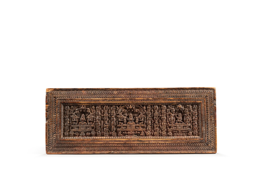 View full screen - View 1 of Lot 4. A carved wood sutra book cover, Tibet, 15th century | 十五世紀 藏傳木刻護經板.
