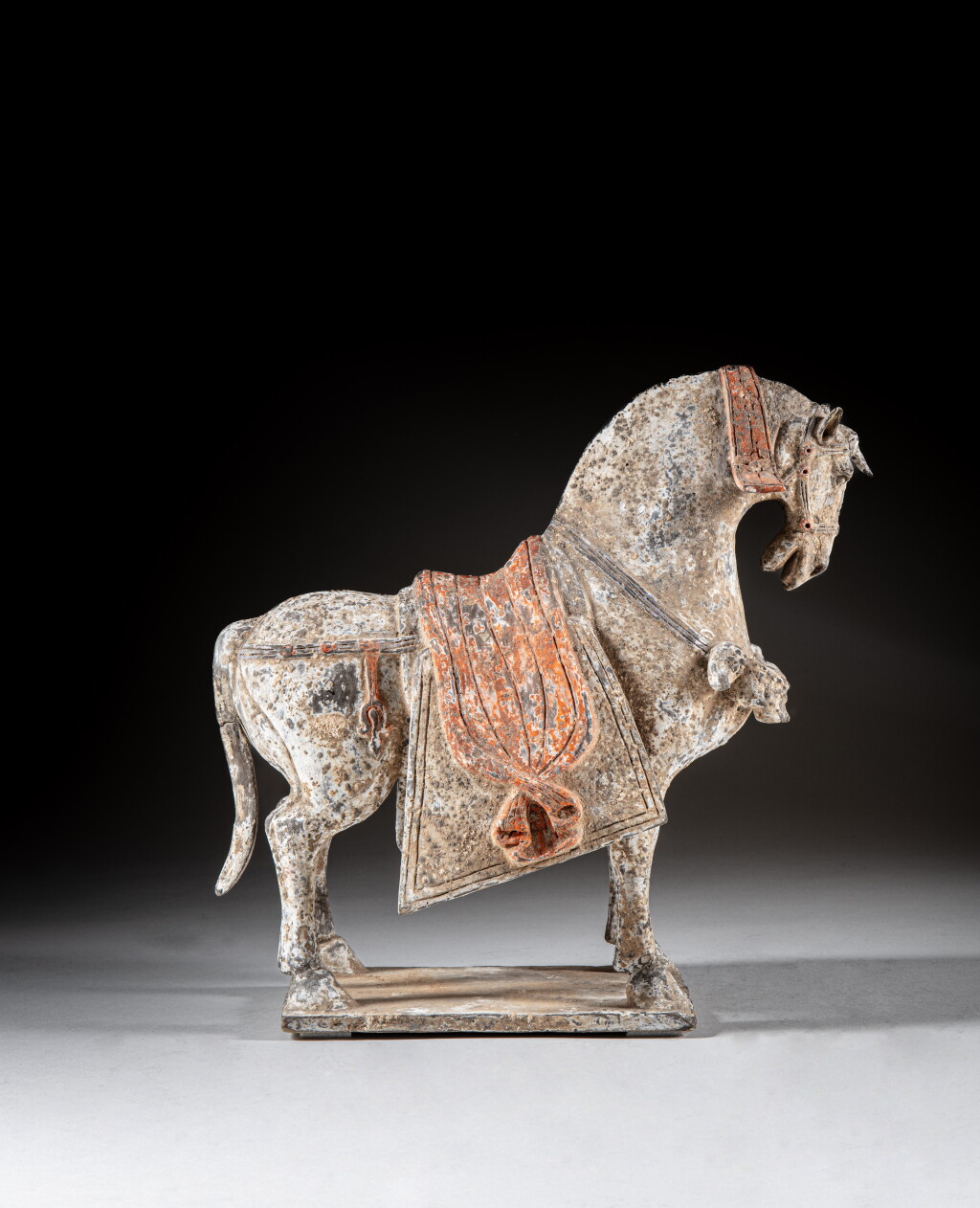 View full screen - View 1 of Lot 303. A painted pottery figure of a caparisoned horse, Northern Wei dynasty.