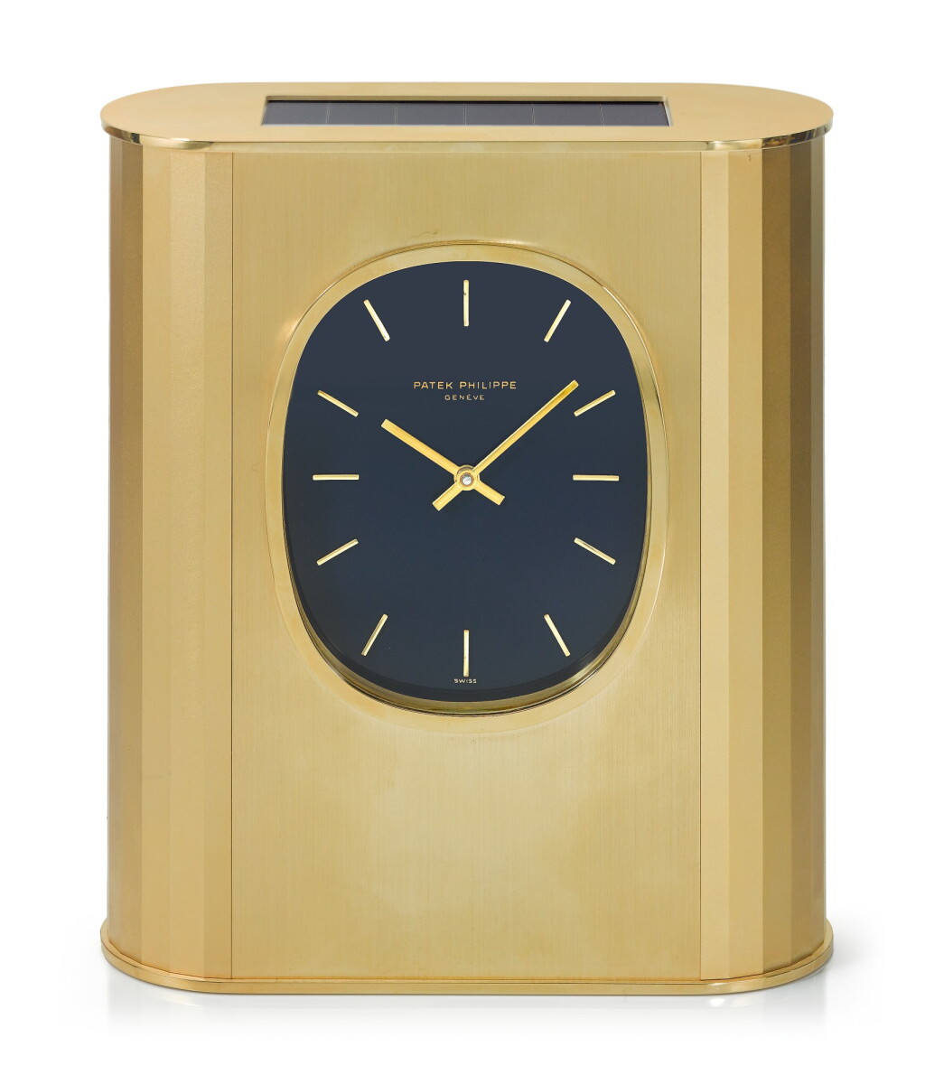 View full screen - View 1 of Lot 43. PATEK PHILIPPE | REFERENCE 31477 ELLIPSE D'OR SOLAR A GILT BRASS SOLAR-POWERED DESK TIMEPIECE, MADE IN 1976.