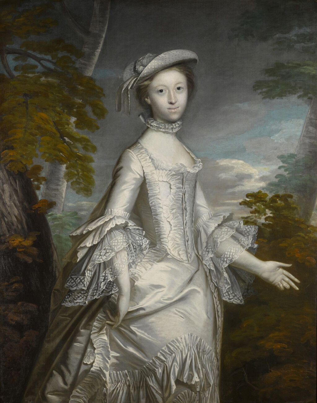 View full screen - View 1 of Lot 192. Portrait of Mrs Anthony Eyre (d. 1800), three-quarter length, wearing a white frilled satin dress, standing in a landscape.