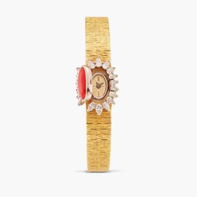 View full screen - View 1 of Lot 127. Reference 1428 A 6 | A yellow gold, diamond, and coral-set concealed dial bracelet watch, Circa 1960.