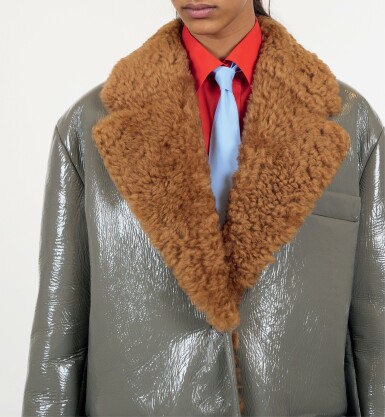 View full screen - View 1 of Lot 21. PRADA | PATENT SHEARLING COAT, WOOL SKIRT, ORGANZA STRETCH SHIRT, POPLIN TIE. UNIQUE READY-TO-WEAR NOT IN THE STORES.