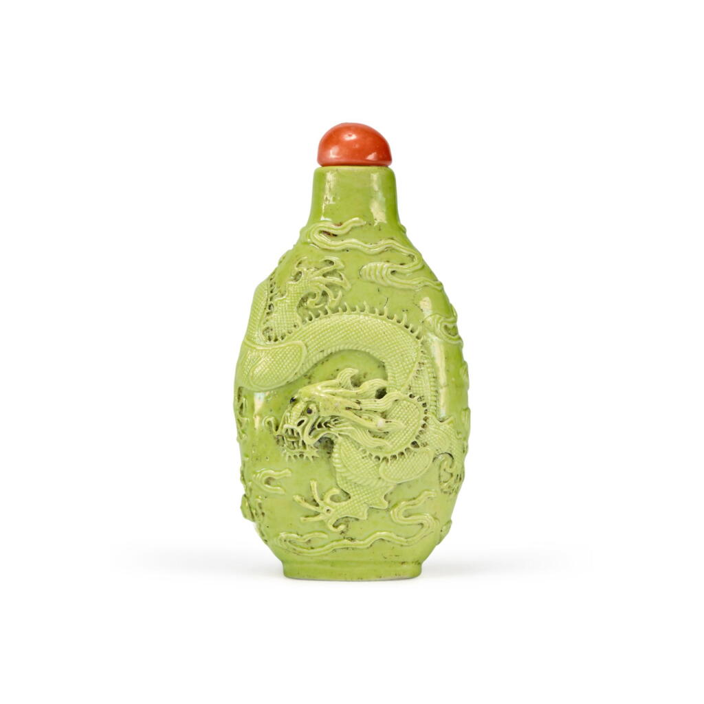 View full screen - View 1 of Lot 831. A molded and lime-green-enameled 'dragon' snuff bottle, Qing dynasty, 19th century | 清十九世紀 檸檬綠釉浮雕龍紋鼻烟壺.