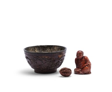 View full screen - View 1 of Lot 161. Bol en noix de coco sculpté, noix sculptée, et, figure d'immortel en stéatite sculptée Dynastie Qing | 清 雜項一組三件 | A pewter-lined 'deers in a landscape' coconut bowl, a finely carved 'eight immortal' nut, and a soapstone figure of a luohan, Qing Dynasty .