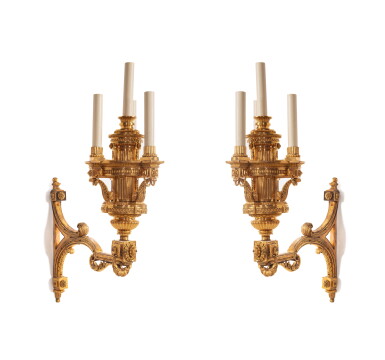 View full screen - View 1 of Lot 46. A pair of Louis XVI gilt-bronze four-light bracket wall-lanterns after designs attributed to Jean-Charles Delafosse, circa 1775.