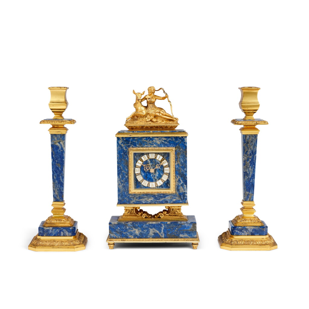 View full screen - View 1 of Lot 1024. An Italian silver-gilt mounted lapis lazuli candlestick and clock garniture, Politi, Milan, mid-20th century.