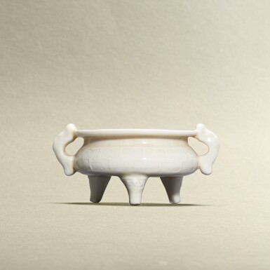 View full screen - View 1 of Lot 5770. A blanc-de-Chine archaistic handled tripod incense burner, Lin Jiesheng mark, Qing dynasty, 19th century | 清十九世紀 德化白釉仿古紋雙魚耳三足爐 《林捷陞製》.