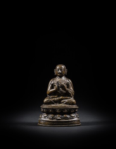 View full screen - View 1 of Lot 53. An inscribed copper-alloy seated figure of a Lama, Tibet, 16th century.
