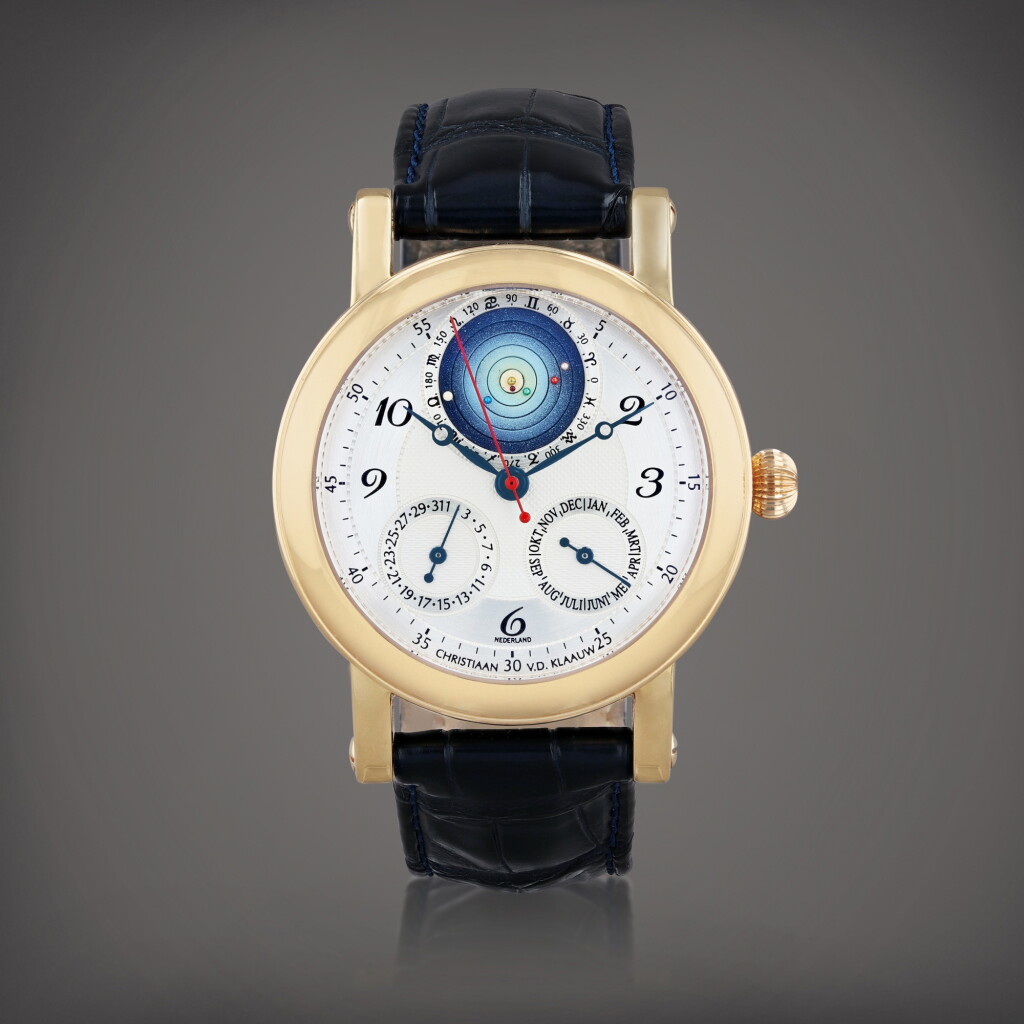 View full screen - View 1 of Lot 460. Planetarium 2000 Montre bracelet en or rose avec mois, date et planétarium représentant la position relative des planètes autour du soleil | Pink gold wristwatch with month, date, and planetarium aperture depicting the relative placement of the planets around the sun Vers 2000 | Circa 2000.