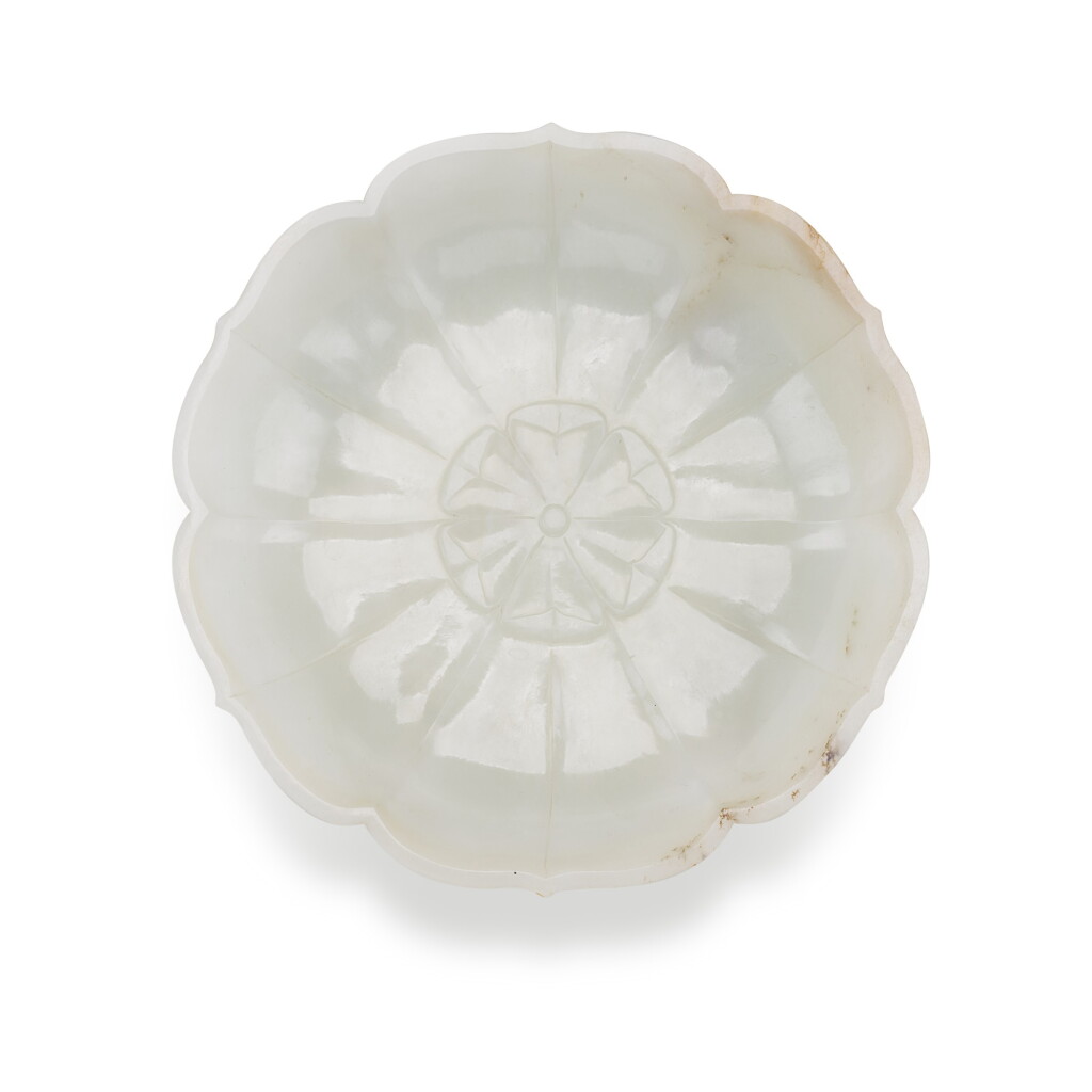 View full screen - View 1 of Lot 96. A celadon jade foliate-shaped dish, Qing dynasty, 18th/19th century | 清十八/十九世紀 青白玉菱口盤.