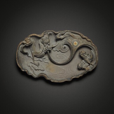 View full screen - View 1 of Lot 609. A Duan stone 'dragon' ink palette, Qing dynasty, 18th / 19th century | 清十八 / 十九世紀 端石雕雲龍戲珠紋筆掭.
