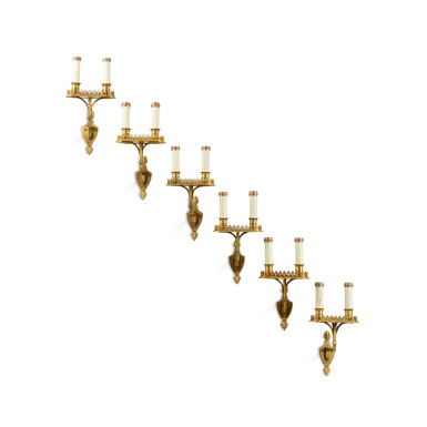 View full screen - View 1 of Lot 1048. A suite of six Louis XVI gilt-bronze four-light wall-lights, 19th century | Suite de six appliques à deux lumières en bronze doré de style Louis XVI, XIXe siècle.
