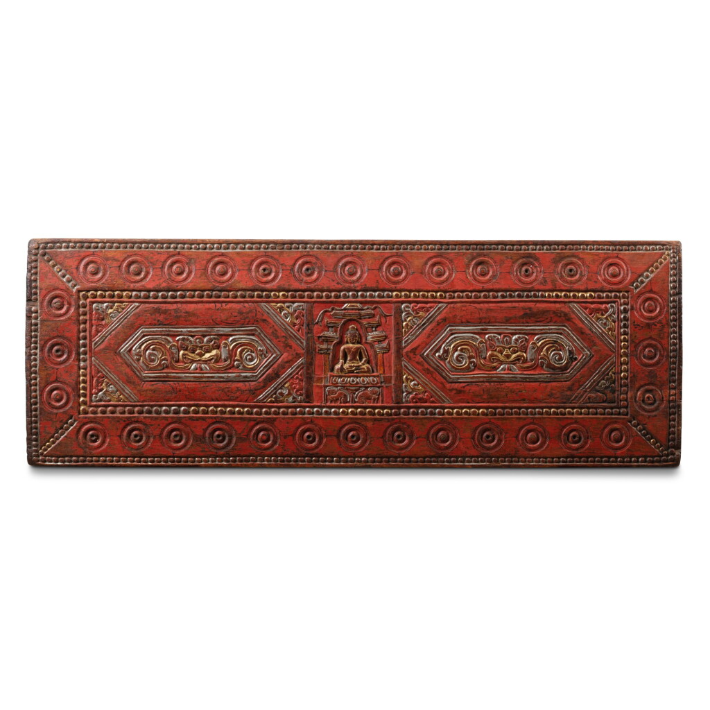 View full screen - View 1 of Lot 100. A silver and gilt-decorated red-lacquered carved wood sutra cover Tibet, 13th-14th century | 西藏 十三至十四世紀 描金銀漆木雕佛像紋經板.