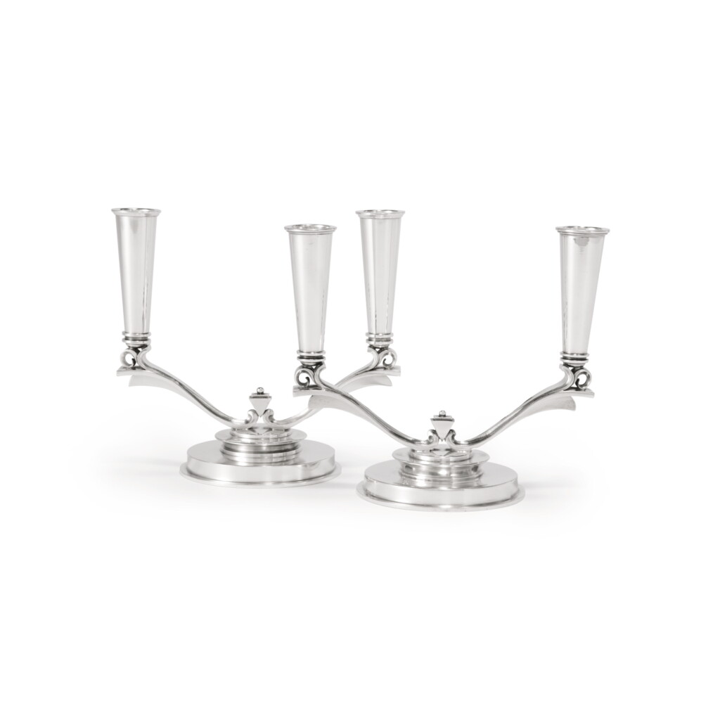 View full screen - View 1 of Lot 10. TWO MATCHING DANISH SILVER TWO-LIGHT CANDELABRA, NO. 630A, DESIGNED BY HARALD NIELSEN, GEORG JENSEN SILVERSMITHY, COPENHAGEN, CIRCA 1933-44 AND 1945-77.