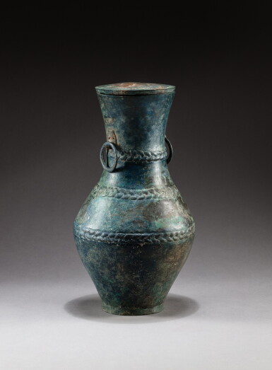 View full screen - View 1 of Lot 97. A bronze vase with lid, hu Han dynasty, 2nd century BC | 漢 公元前二世紀 青銅雙環耳蓋壺.