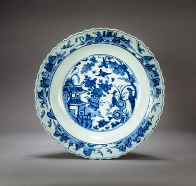 View full screen - View 1 of Lot 193. A large blue and white barbed-rim 'flower and bird' dish Ming dynasty, Wanli period | 明萬曆 青花樓閣花鳥紋菱口折沿盤.