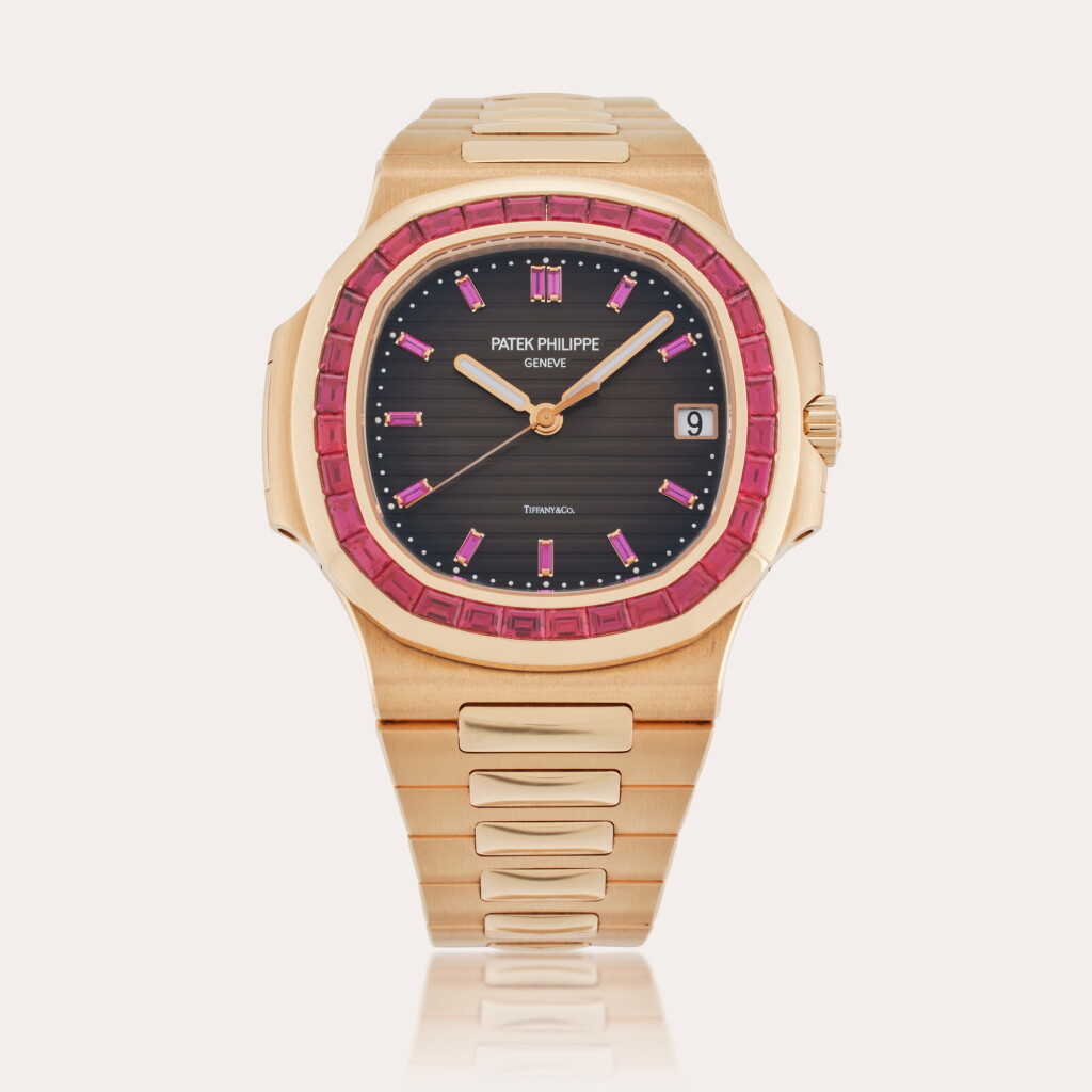 View full screen - View 1 of Lot 77. Reference 5723/112R-001 Nautilus | Retailed by Tiffany & Co.: A pink gold and ruby-set automatic wristwatch with date and bracelet, Circa 2018.
