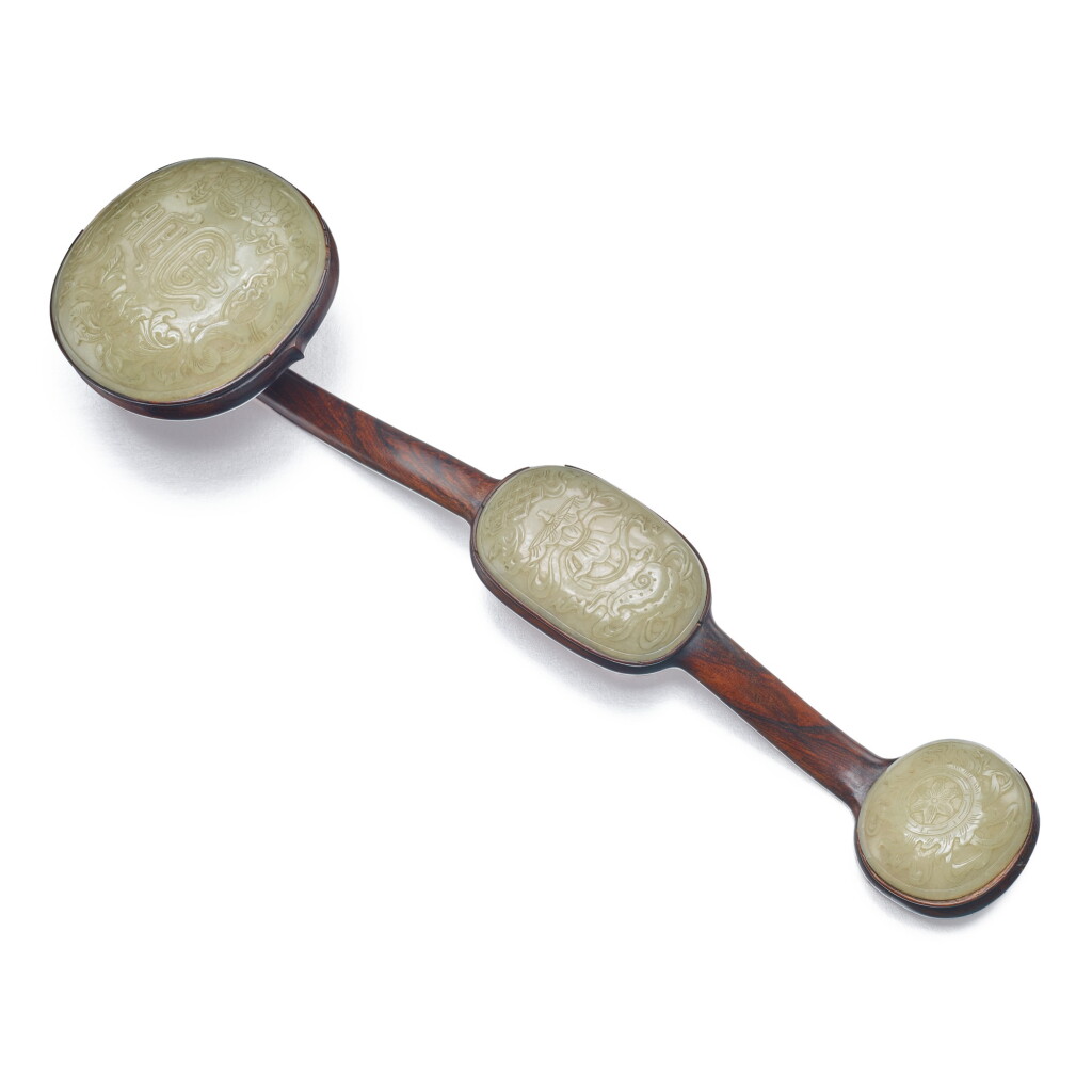 View full screen - View 1 of Lot 32. A pale celadon jade-inset 'hongmu' ‘eight auspicious emblems’ ruyi scepter, Qing dynasty, 19th century | 清十九世紀 紅木嵌青白玉雕八吉祥壽字紋三鑲如意.