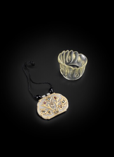 View full screen - View 1 of Lot 195. A small Mughal style embellished celadon jade pendant and a rock crystal archer ring, Probably India, 19th century | 或為印度 十九世紀 痕都斯坦式玉珮及水晶扳指一組兩件.