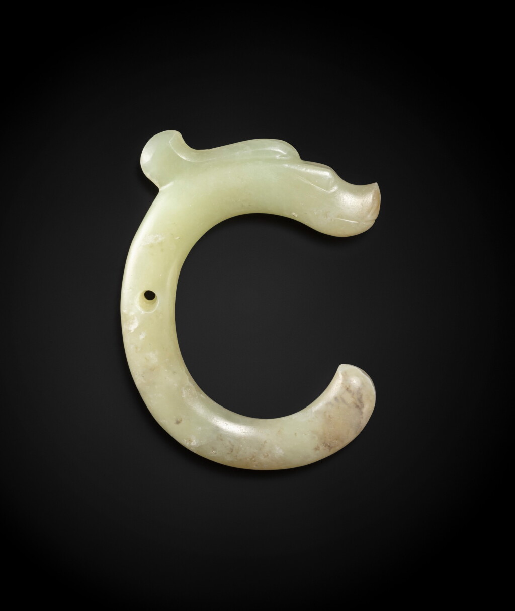 View full screen - View 1 of Lot 86. An important celadon jade ‘C-shaped' 'dragon' pendant Neolithic period, Hongshan culture | 新石器時代 紅山文化青白玉龍形珮.