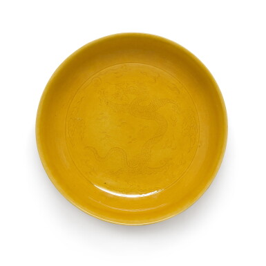 View full screen - View 1 of Lot 203. An incised yellow-glazed 'dragon' dish, Seal mark and period of Daoguang | 清道光 黃釉暗刻雲龍紋盤《大清道光年製》款.