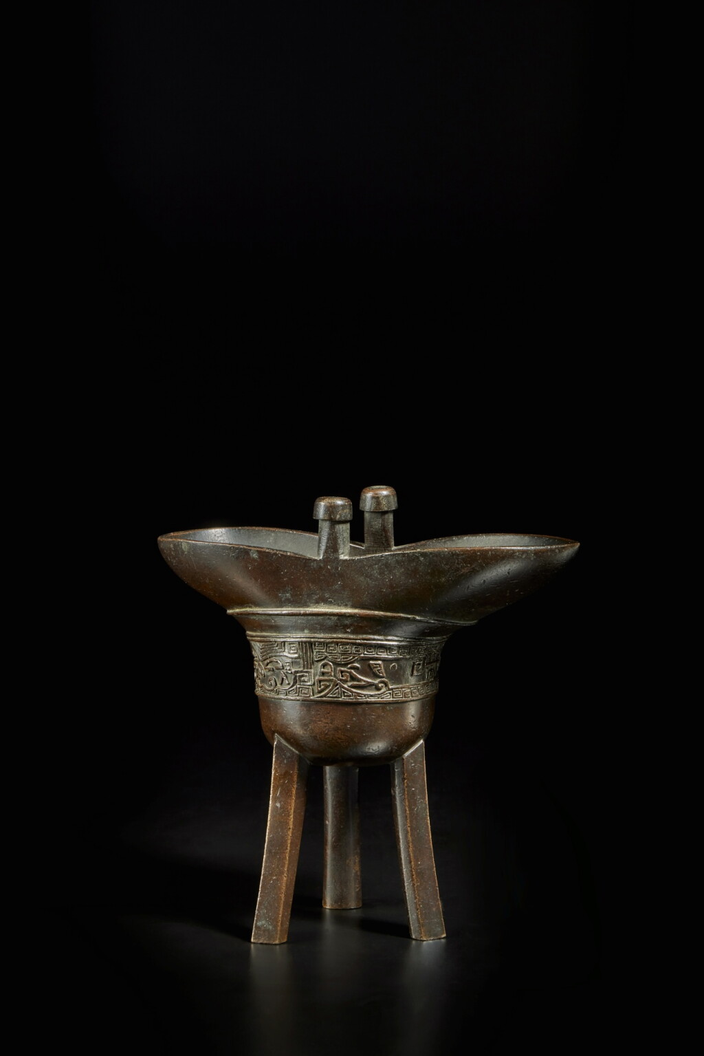 View full screen - View 1 of Lot 206. An archaistic bronze tripod vessel, jue, Seal mark and period of Qianlong .